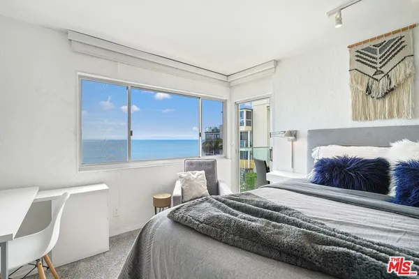 a bedroom with double bed and a dresser