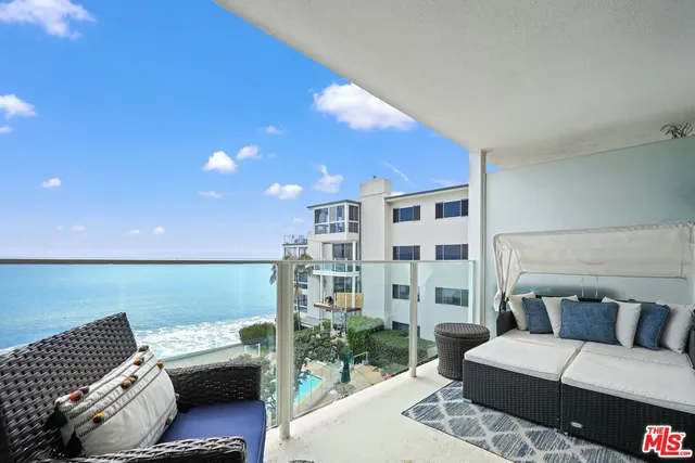 a living room with furniture a wooden floor and a window