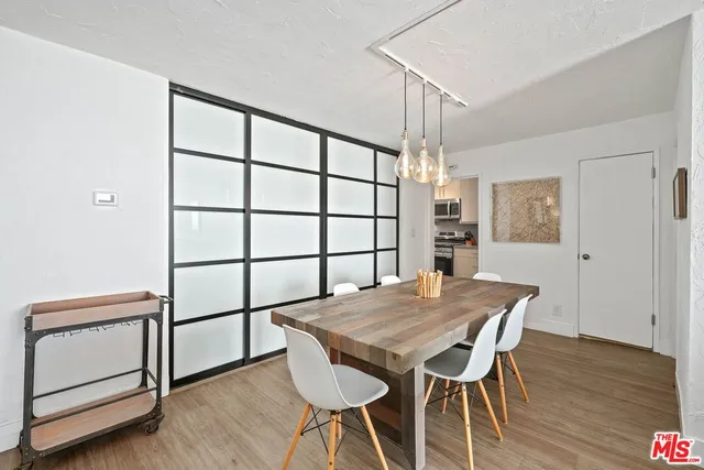 a view of a dining room with furniture and wooden floor