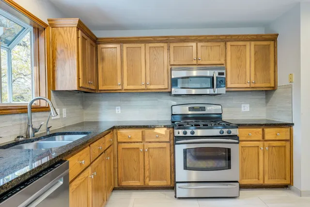 a kitchen with granite countertop a stove top oven