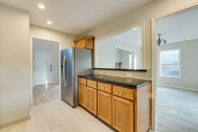 a kitchen with stainless steel appliances granite countertop a refrigerator and a sink