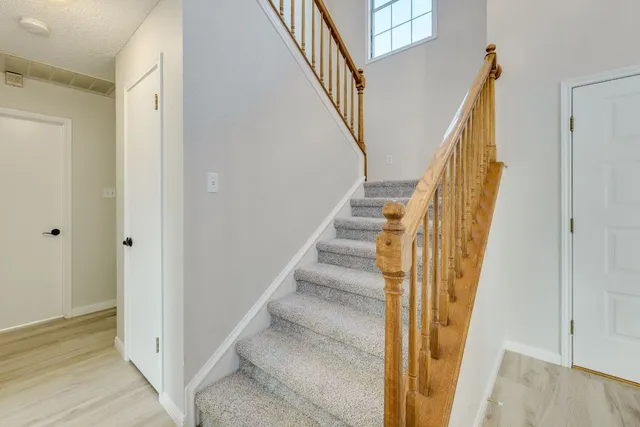 a view of staircase with wooden floor and staircase