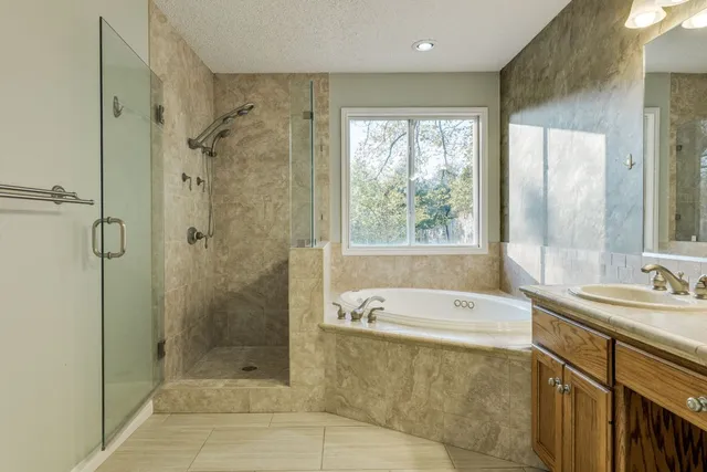a spacious bathroom with a shower and a bathtub
