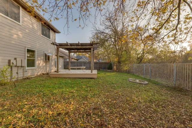 a view of a garden with large trees