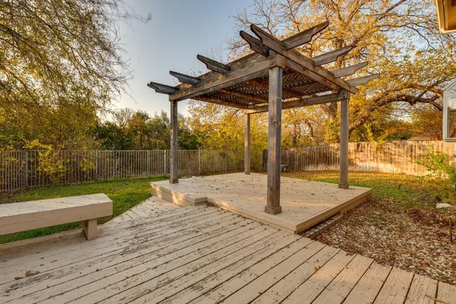 a backyard of a house with fountain table and chairs