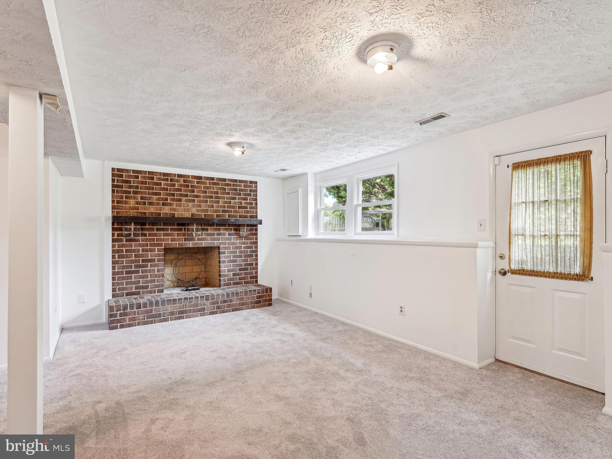 6310 Meeting House Way Alexandria, VA 22312 - Photo 25 of 30 Fireplace, windows, door to backyard