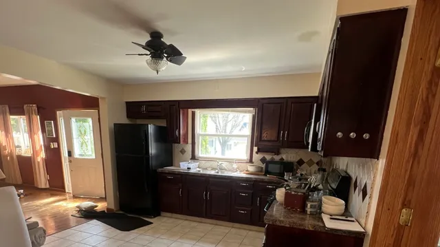 a kitchen with a refrigerator and a sink