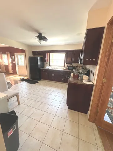 a living room with couches and furniture with kitchen view