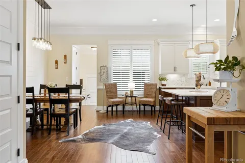 a view of a a dining room with furniture window and wooden floor