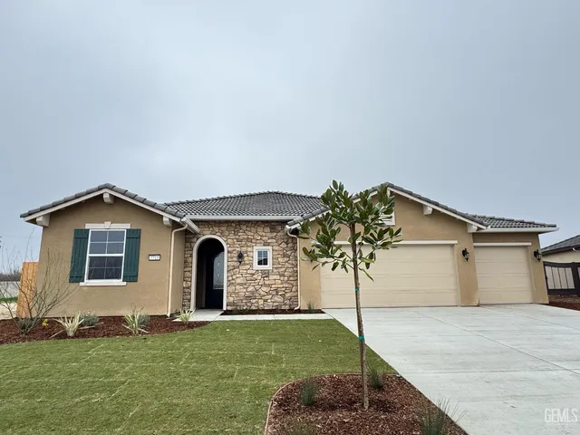 a front view of a house with a garden