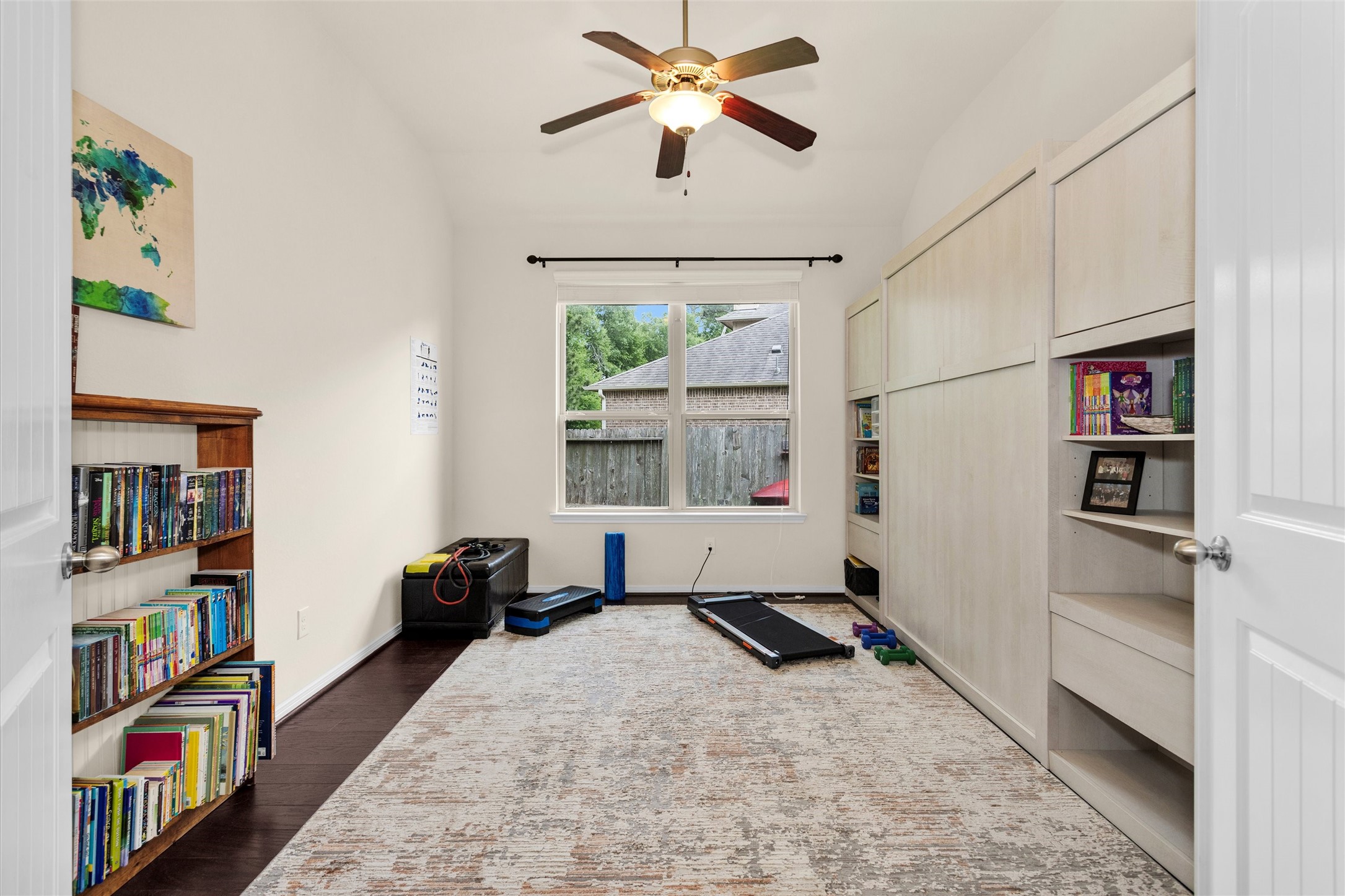 14105 Sun Notch Drive Conroe, TX 77384 - Photo 13 of 31 a bed room with a bed and a book shelf