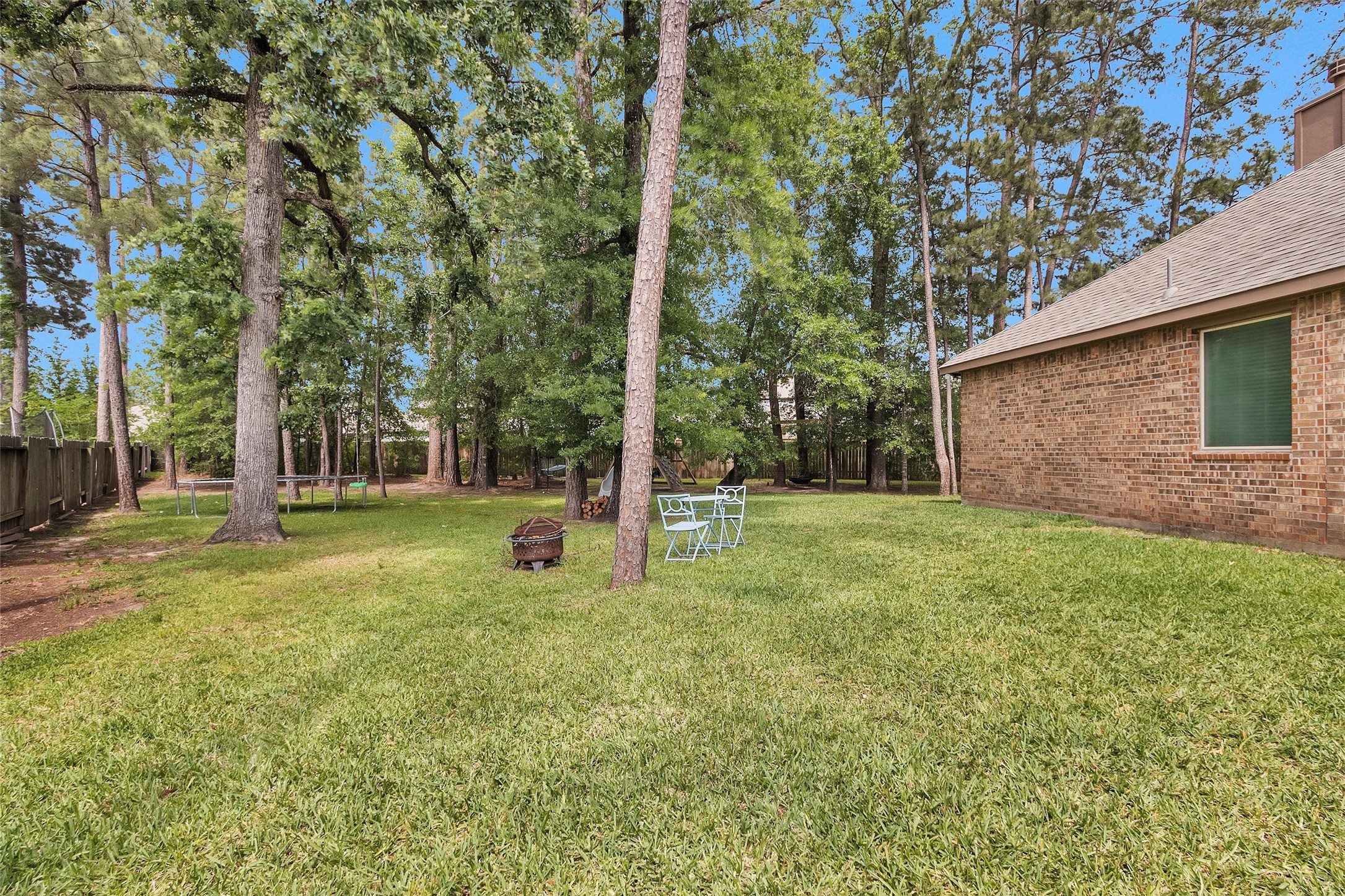 14105 Sun Notch Drive Conroe, TX 77384 - Photo 31 of 31 a view of a house with backyard and a tree