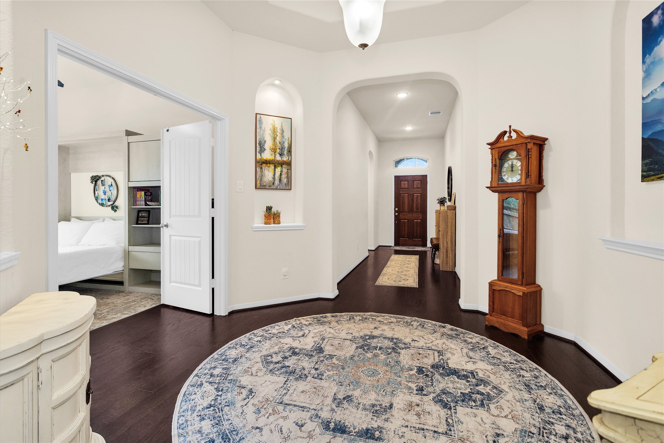 14105 Sun Notch Drive Conroe, TX 77384 - Photo 4 of 31 a view of a hallway with wooden floor and furniture