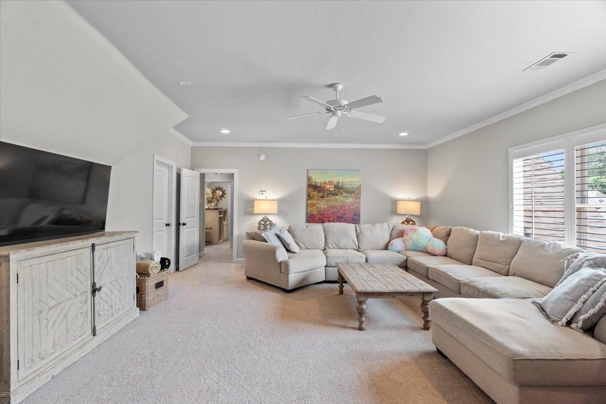 12531 Bravo Road Collierville, TN 38017 - Photo 36 of 40 Living area featuring light colored carpet, a ceiling fan, ornamental molding, and recessed lighting