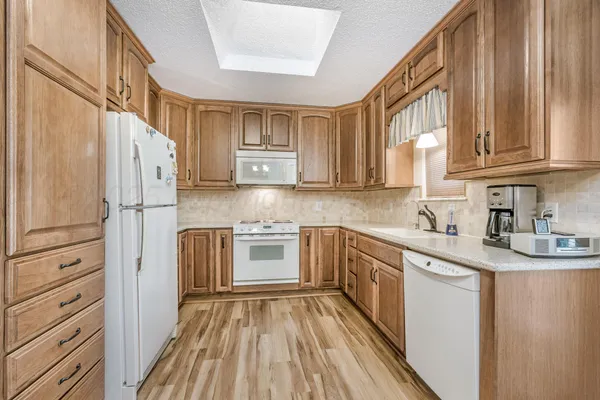a kitchen with stainless steel appliances granite countertop a refrigerator sink and cabinets