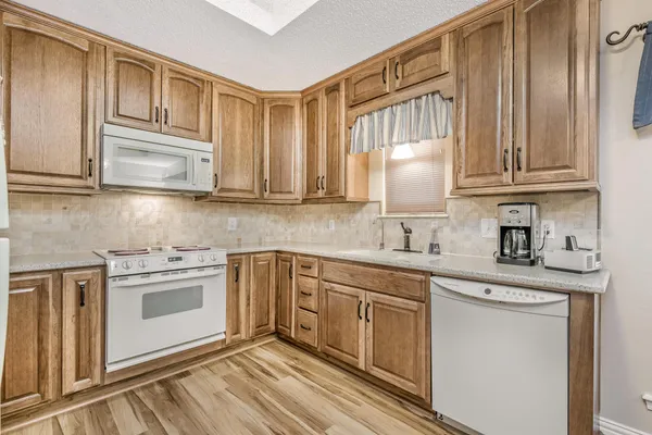 a kitchen with stainless steel appliances granite countertop a sink and cabinets