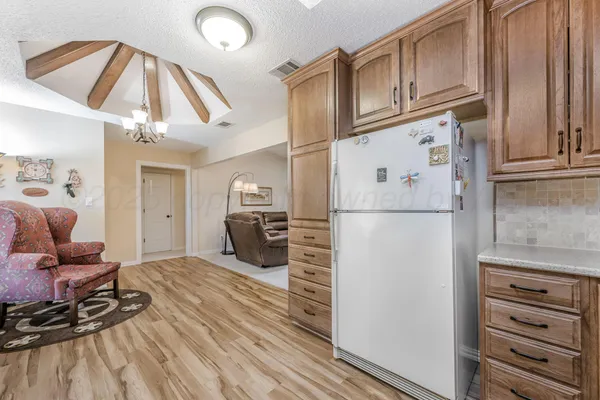 a kitchen with stainless steel appliances granite countertop a refrigerator and microwave