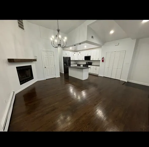 a view of livingroom with kitchen island furniture and fireplace