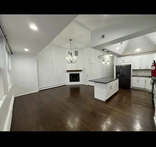 a view of kitchen with furniture and wooden floor