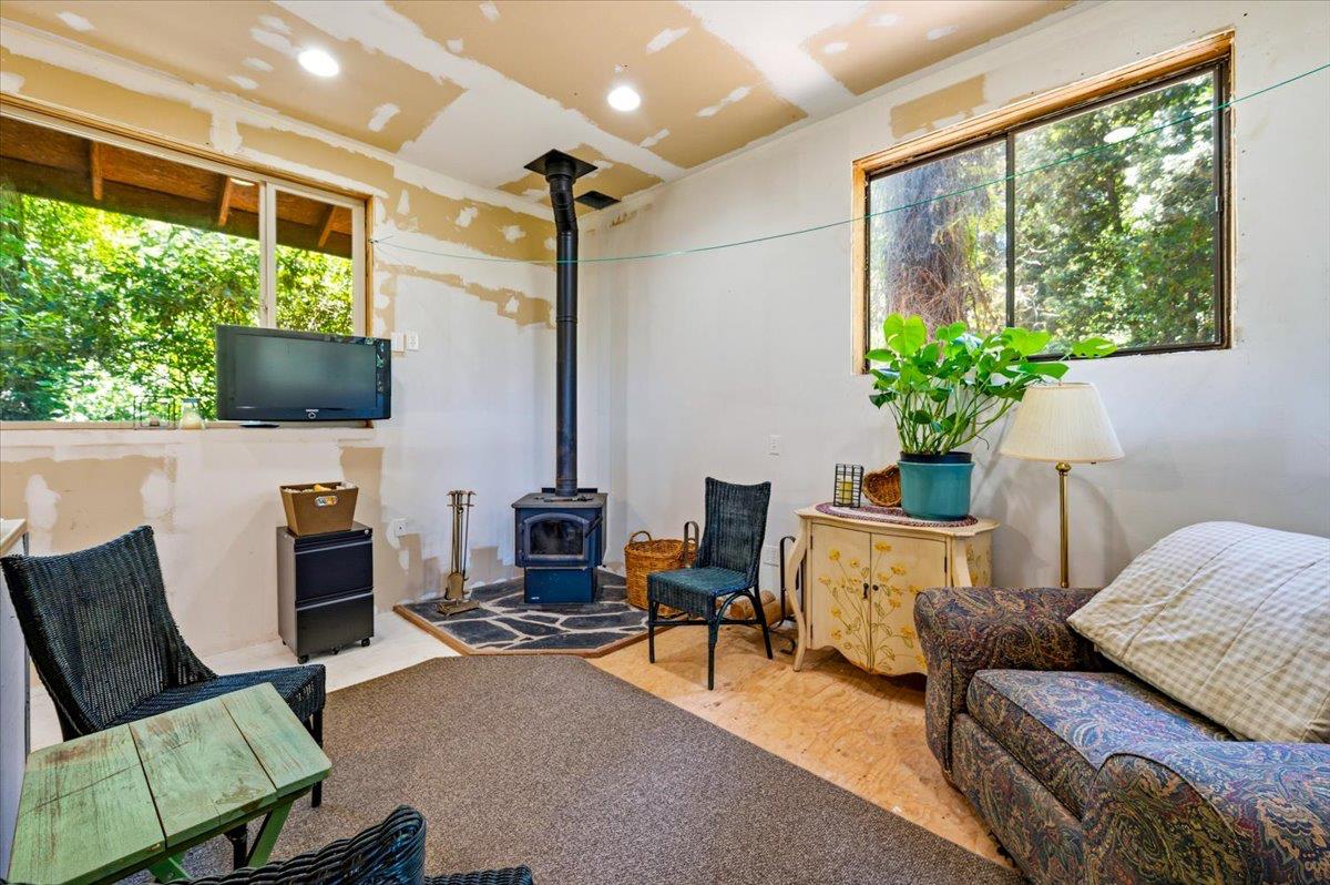 19643 Sages Road Nevada City, CA 95959 - Photo 9 of 39 a living room with furniture fireplace and potted plants