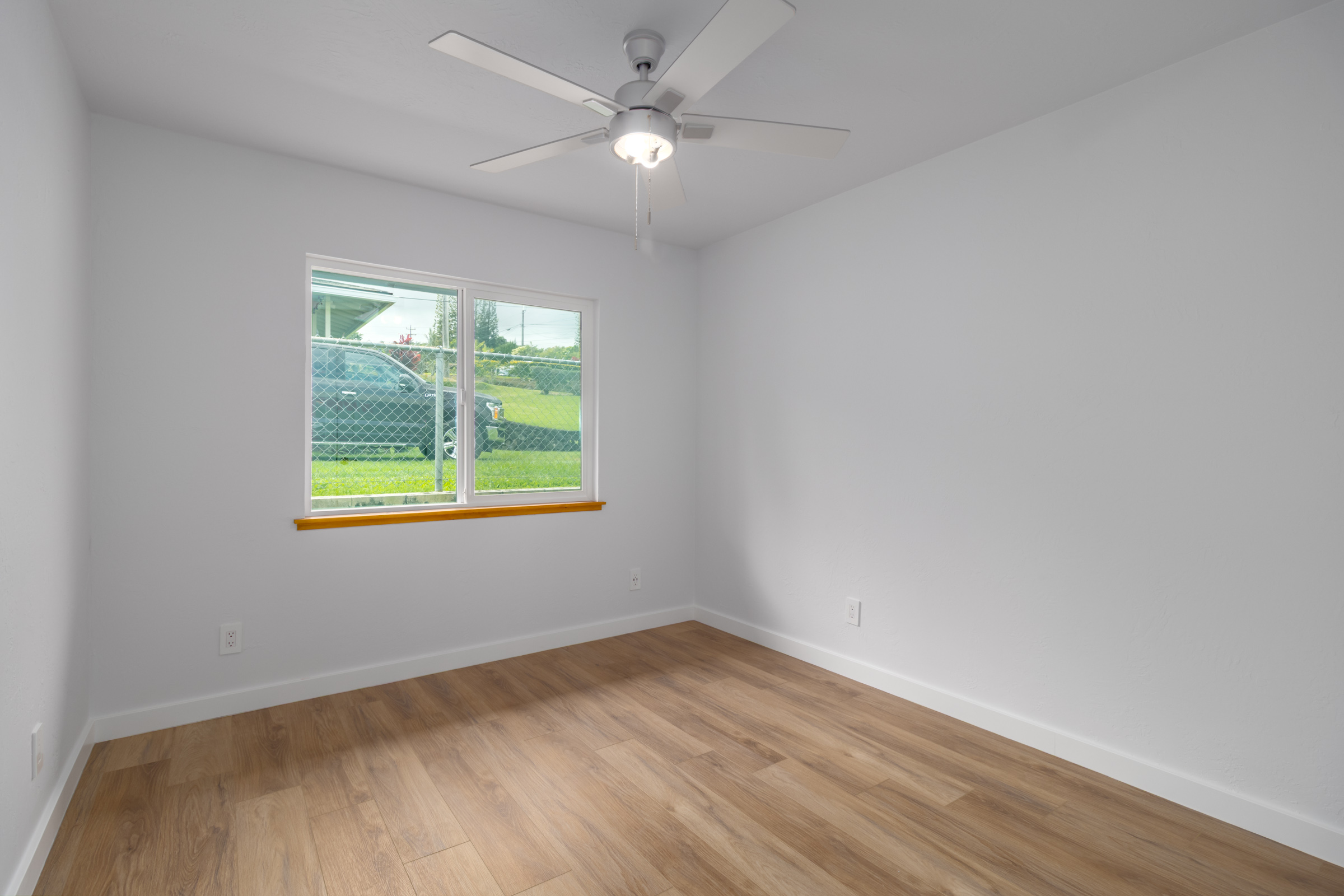 54-2378 Kynnersley Road Kapaau, HI 96755 - Photo 12 of 24 an empty room with wooden floor and windows