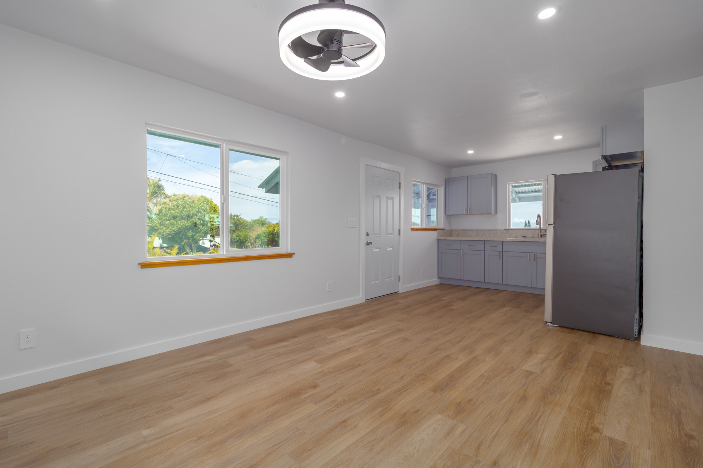 54-2378 Kynnersley Road Kapaau, HI 96755 - Photo 4 of 24 an empty room with windows and refrigerator