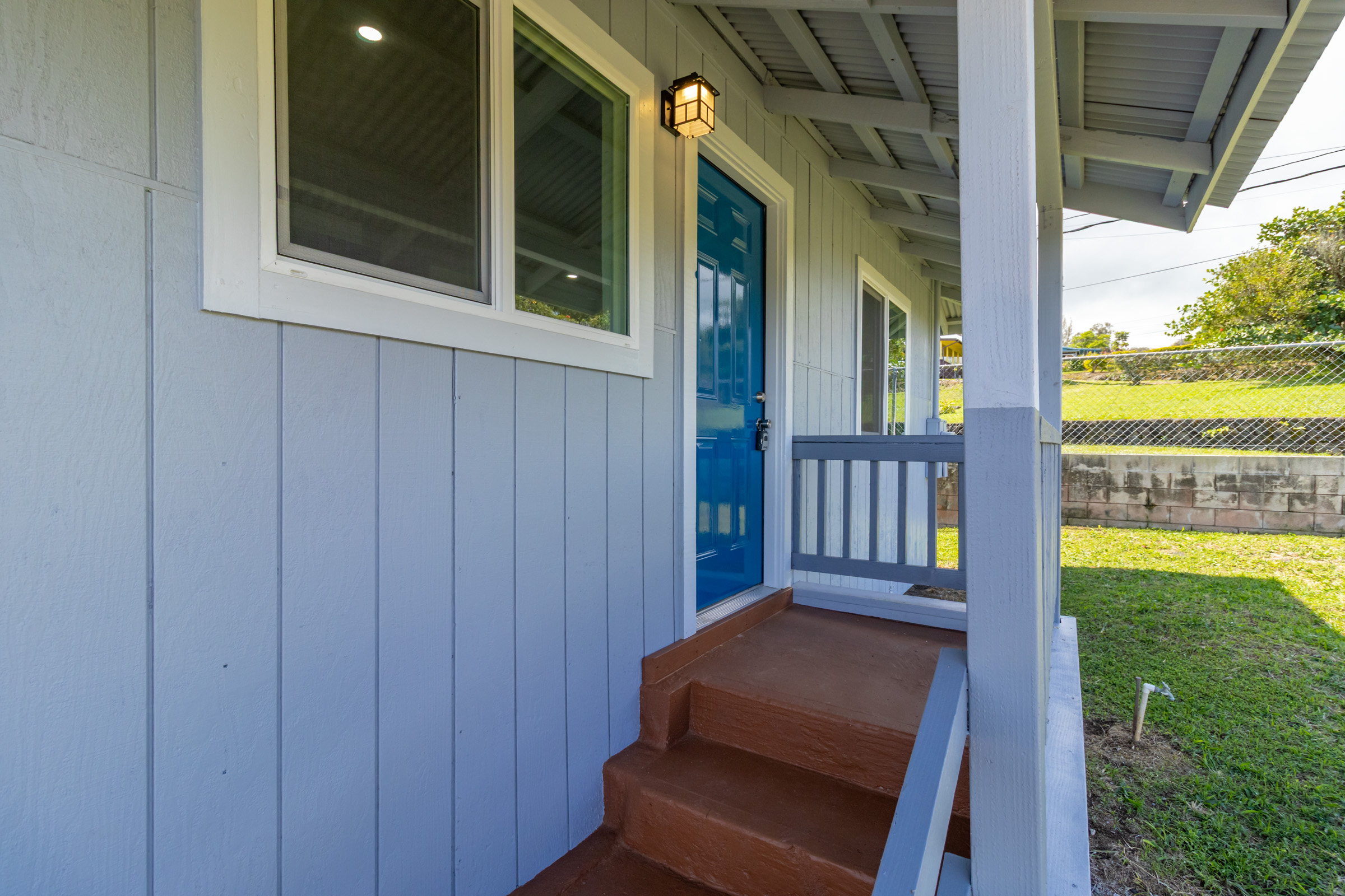 54-2378 Kynnersley Road Kapaau, HI 96755 - Photo 9 of 24 a view of a porch with a chair and floor to ceiling window yard