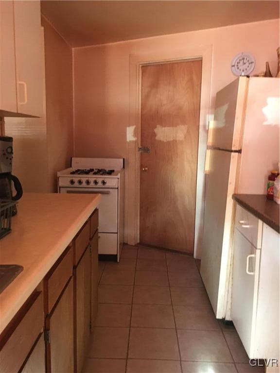 1247 Jackson Street Easton, PA 18042 - Photo 11 of 30 a kitchen with a refrigerator and a stove top oven