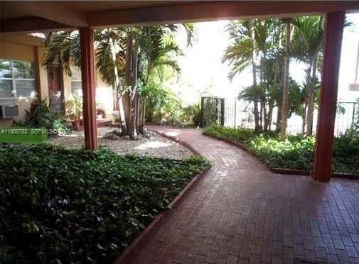 a view of swimming pool with seating area and small garden