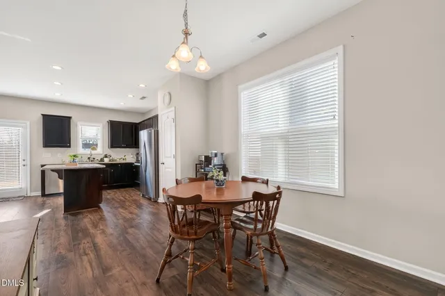a view of a dining room with furniture and window