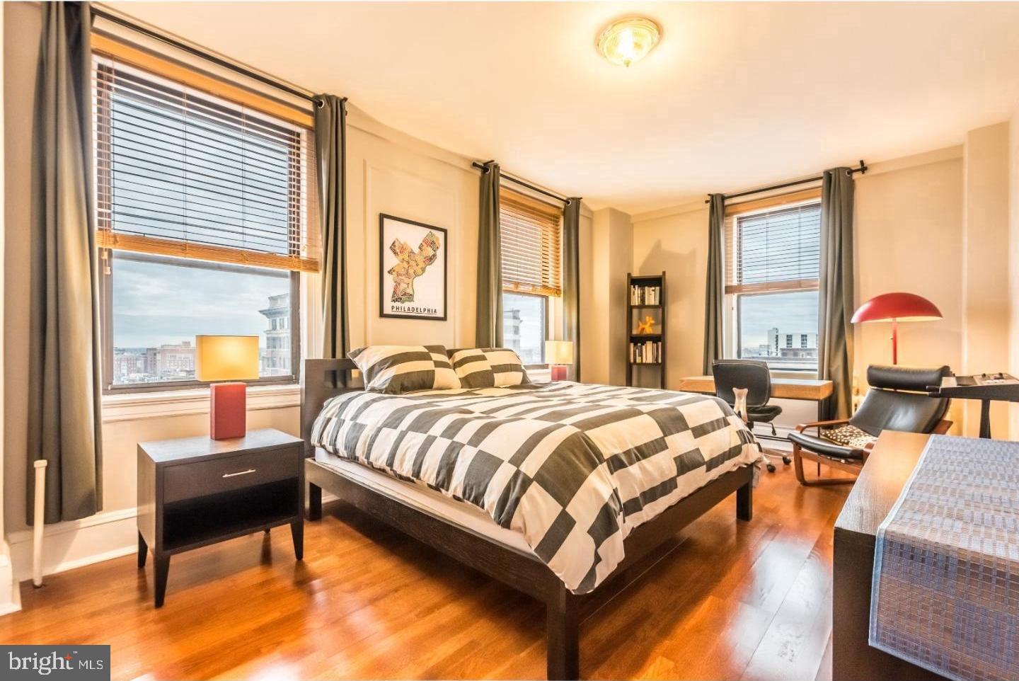 1324 Locust Street, Unit 1125 Philadelphia, PA 19107 - Photo 4 of 8 a spacious bedroom with a bed and wooden floor