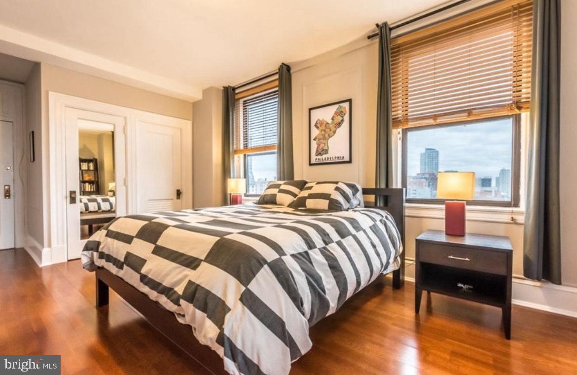 1324 Locust Street, Unit 1125 Philadelphia, PA 19107 - Photo 5 of 8 a bedroom with a bed and wooden floor