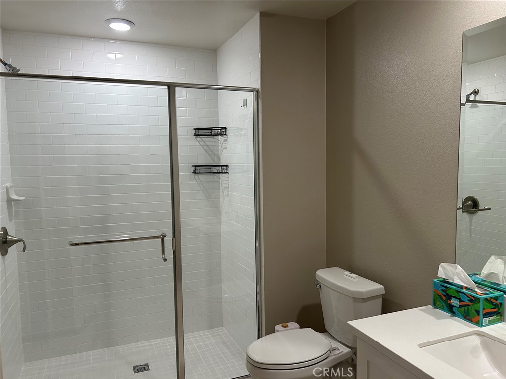 202 Tribeca Irvine, CA 92612 - Photo 13 of 21 a white toilet sitting next to a bathroom sink