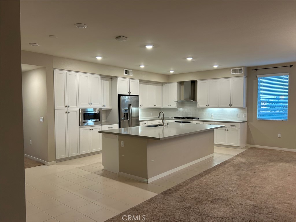 202 Tribeca Irvine, CA 92612 - Photo 3 of 21 a kitchen with stainless steel appliances granite countertop a refrigerator and a sink