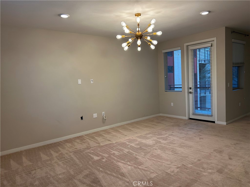 202 Tribeca Irvine, CA 92612 - Photo 4 of 21 a view of an empty room with chandelier fan and a window