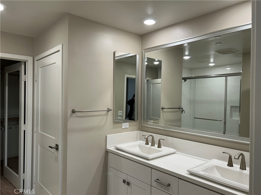 202 Tribeca Irvine, CA 92612 - Photo 7 of 21 a bathroom with a sink and a large mirror