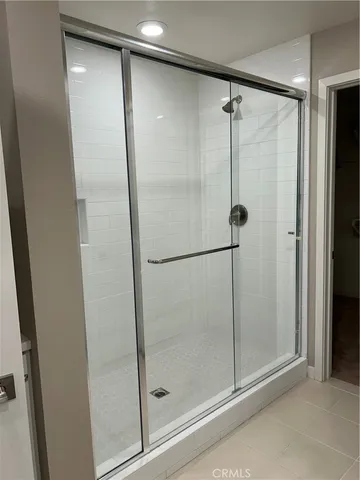 a bathroom with a glass shower door