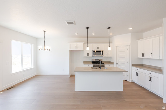 5224 South Acacia Drive, Unit 809 Mapleton, UT 84664 - Photo 6 of 23 Open-concept kitchen and dining area with light wood-finish flooring