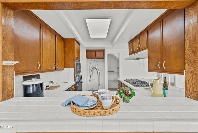 a kitchen with a refrigerator and a stove top oven