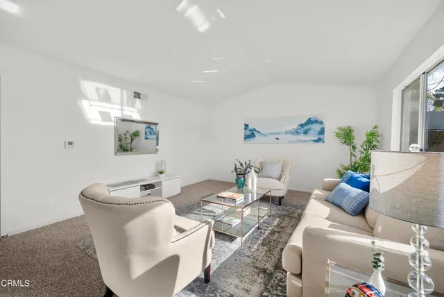 a living room with furniture and a potted plant