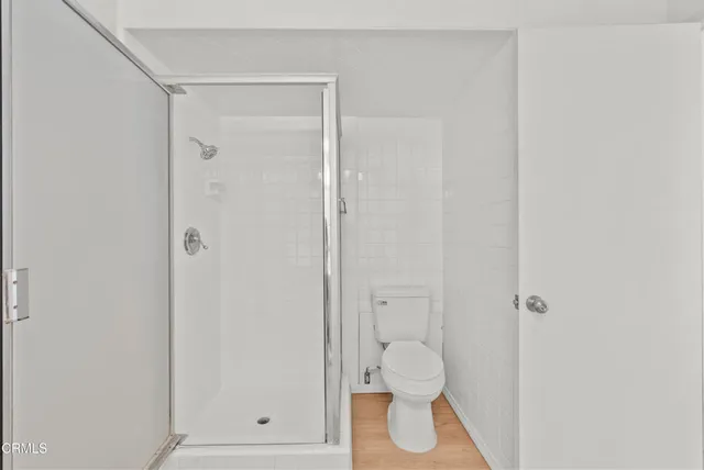a bathroom with a toilet and a shower