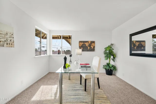 a living room with furniture and flowers