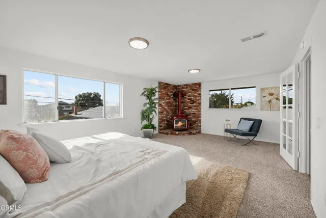 a bed room with a bed and a chair