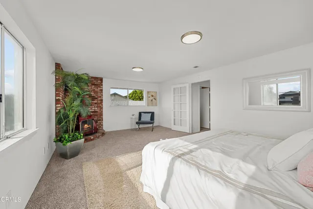 a spacious bedroom with a bed and a window