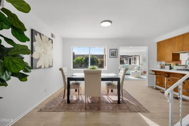 a dining room with furniture and wooden floor