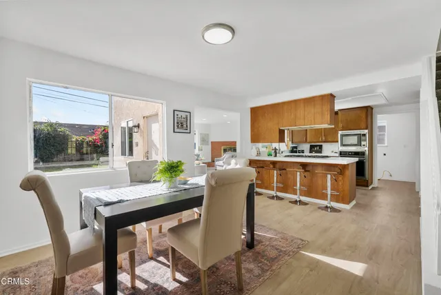 a dining room with furniture and window