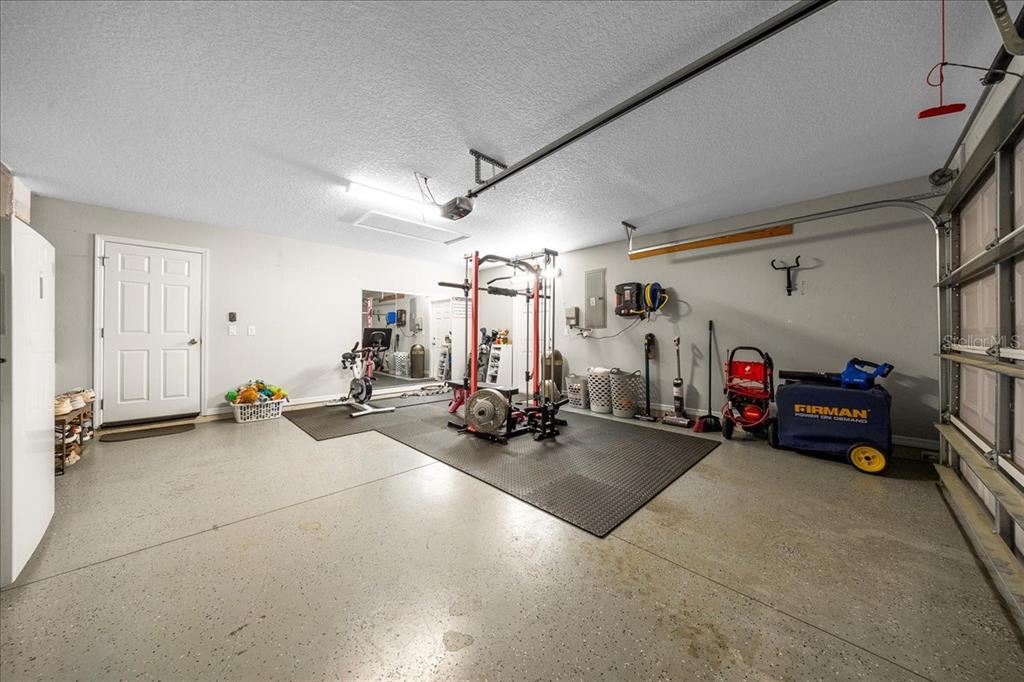 13 Teak Loop Place Ocala, FL 34472 - Photo 25 of 36 a view of a garage with a bike and car