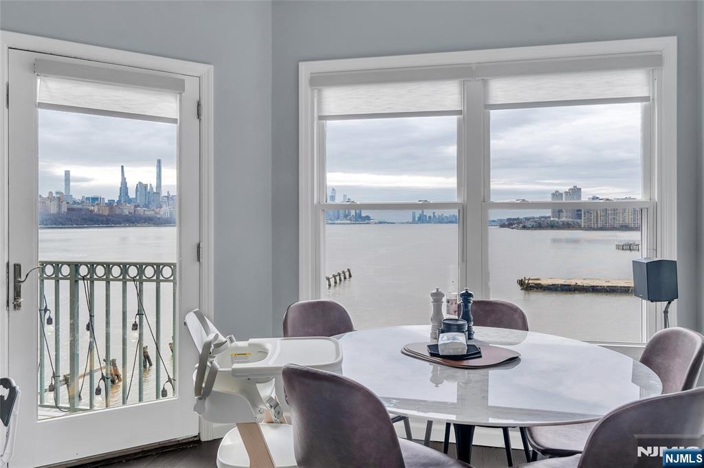314 The Promenade Edgewater, NJ 07020 - Photo 11 of 37 a view of a dining room with furniture window and wooden floor