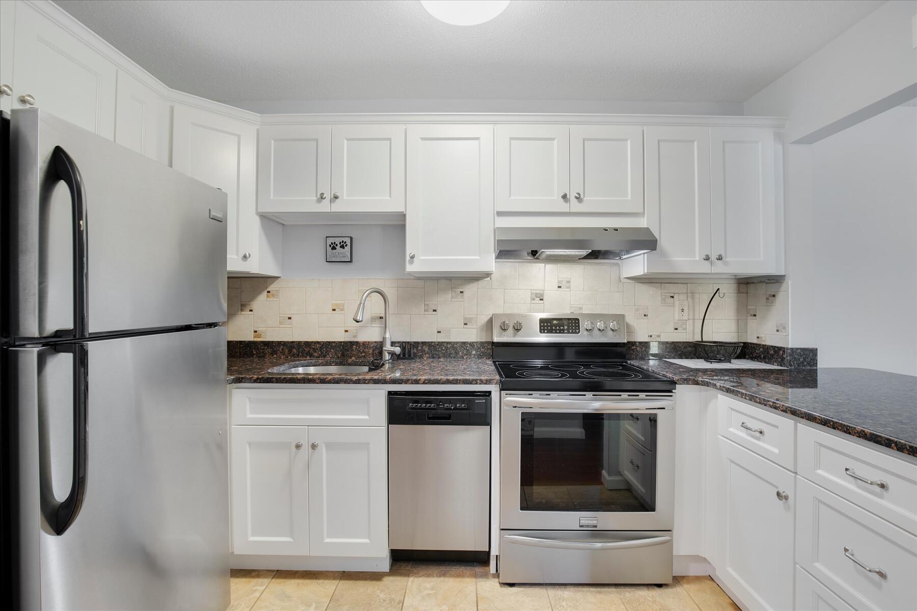 800 Bearses Way, Unit 1EB Hyannis, MA 02601 - Photo 13 of 37 a stove top oven sitting inside of a kitchen
