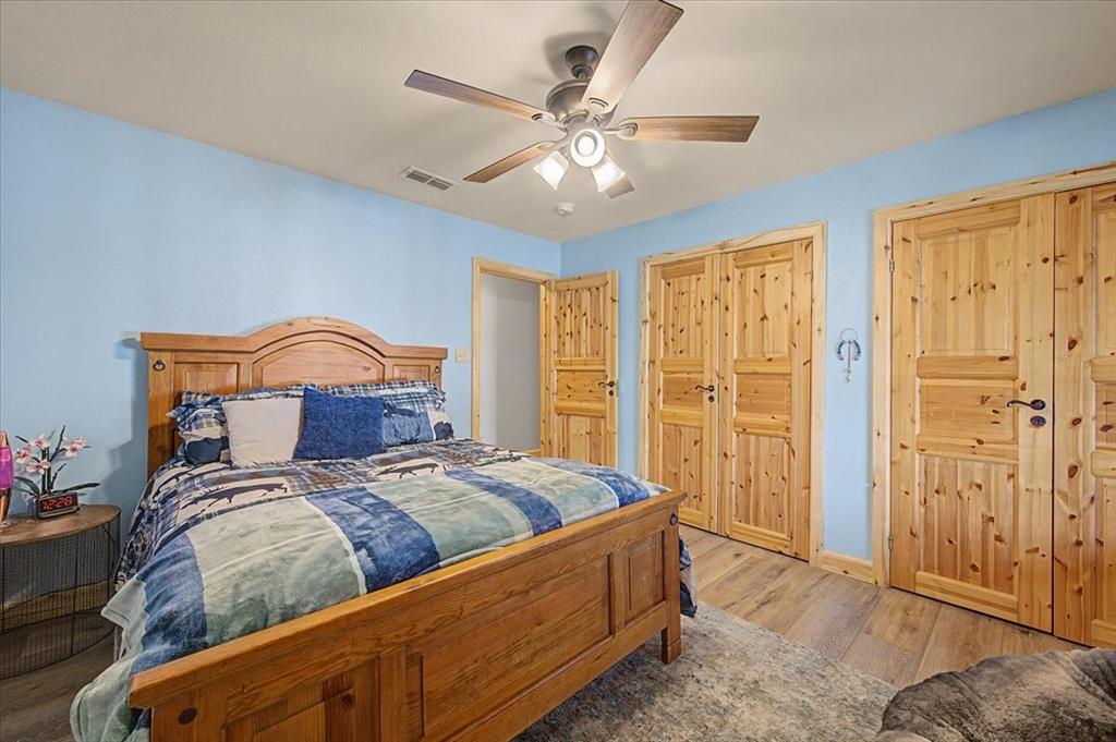 2789 Hanging Tree Road Bowie, TX 76230 - Photo 21 of 40 Wood-finish flooring with multiple paneled wood doors, ceiling fan, and recessed lighting